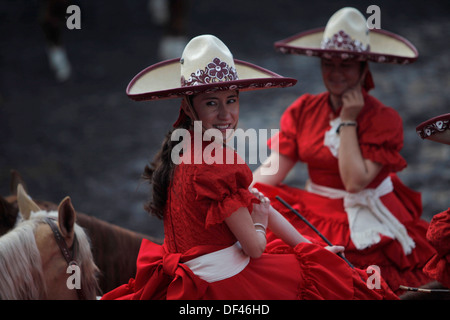 Two female amazon riders ride their horses during an escaramuza fair at the National de Charros's lienzo, in Mexico City. Stock Photo