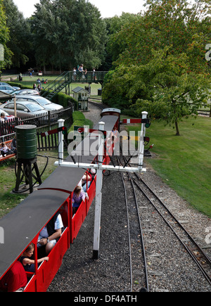 Ride on miniature railway train leaving station at Audley End Saffron Walden Essex England Stock Photo