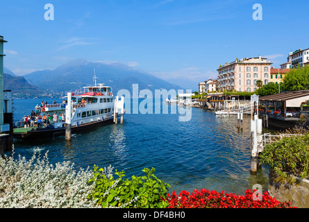 Lake Como. Ferry unloading at dock with historic Hotel Genazzini / Metropole on waterfront to right, Bellagio,Lombardy, Italy Stock Photo