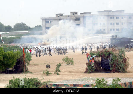 Elite Force Commandos of Police are showing their talent during 28th-29th passing out parade held at Razzaqabad Police Training Center of Karachi on Friday, September 27, 2013. Stock Photo