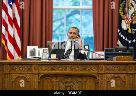 Washington, DC, USA. 27th Sep, 2013. US President Barack Obama talks with President Hassan Rouhani of Iran during a phone call from the Oval Office in the White House September 27, 2013 in Washington, DC. Credit:  Planetpix/Alamy Live News Stock Photo