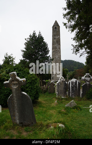The ancient round tower in Glendalough, part of Wicklow National Park. Glendalough is a world famous ancient monastic site. Stock Photo