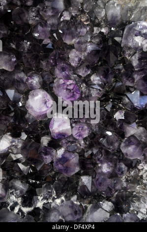 Detail of amethyst crystals inside enormous rock geode Stock Photo