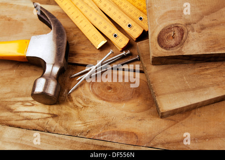 Nails, hammer and folding ruler on wood Stock Photo