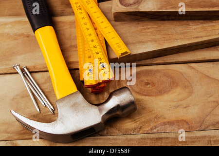 Nails, hammer and folding ruler on wood Stock Photo