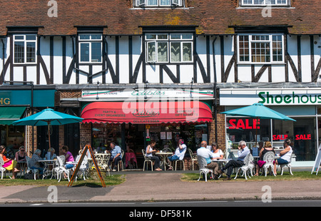 'Edibles' delicatessen/cafe with many people sitting outside in summer. Banstead high street, Surrey, England, UK. Stock Photo