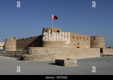 Arad Fort in Muharraq, Kingdom of Bahrain, with the Bahrain flag flying Stock Photo