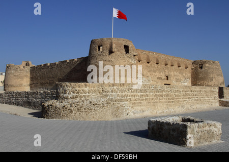 Arad Fort in Muharraq, Kingdom of Bahrain, with the Bahrain flag flying Stock Photo