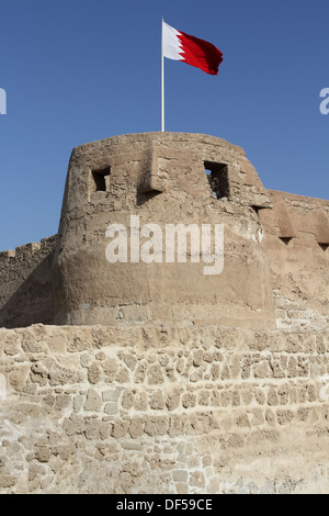 Arad Fort in Muharraq, Kingdom of Bahrain, with the Bahrain flag flying Stock Photo