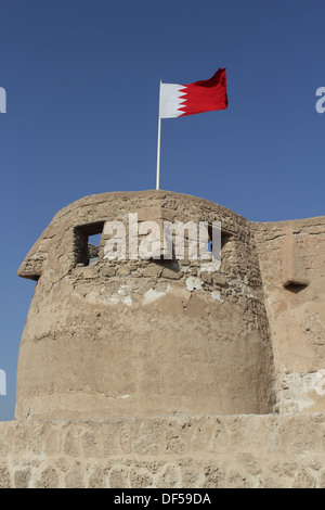 Arad Fort in Muharraq, Kingdom of Bahrain, with the Bahrain flag flying Stock Photo