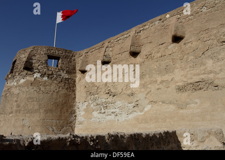 Arad Fort in Muharraq, Kingdom of Bahrain, with the Bahrain flag flying Stock Photo