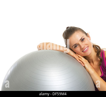 Portrait of brunette fitness girl, laying on yoga mat at home, watching  workout tutorials, videos on smartphone, wearing sportswear and wireless  Stock Photo - Alamy