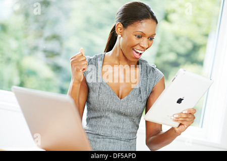Woman happy looking at her iPad Stock Photo
