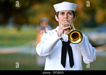 US Navy sailor Musician 1st Class Amanda Marquis from Fleet Forces Band plays Taps during a Prisoner of War and Missing in Action Remembrance ceremony at the Flame of Hope Memorial at Naval Air Station Oceana September 20, 2013 in Virginia Beach, VA. Stock Photo