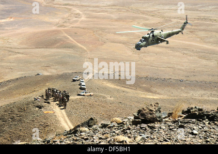 An Afghan air force Mi-35 helicopter gunship flies over a group of Afghan National Army soldiers with 4th Infantry Brigade during a live-fire air to ground integration exercise September 18, 2013 in Logar province, Afghanistan.