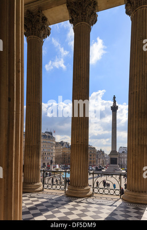 Nelson Column Trafalgar Square viewed through columns of the National Gallery London England Stock Photo