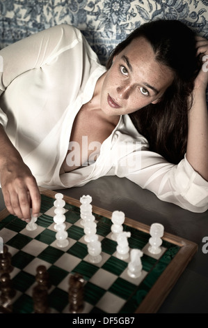 Teenage girl playing chess Stock Photo