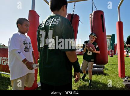 Tampa, Florida, USA. 28th Sep, 2013. DANIEL WALLACE | Times.Caileb Salazar, 9, left, and Mateo Slivka, 10, watch as Ryan Gillespie, 9, runs through the a set of football dummies as fans tailgate before the University of South Florida football game against the Miami Hurricanes at Raymond James Stadium on Saturday, September 28, 2013. © Daniel Wallace/Tampa Bay Times/ZUMAPRESS.com/Alamy Live News Stock Photo