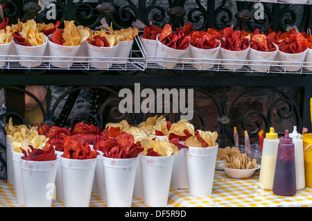 Red and yellow potato chips being sold from a stall in Mexico City Stock Photo