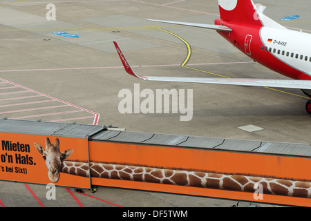 Passenger skywalk with an advert for Sixt car rental, Dusseldorf International airport, Germany. Stock Photo