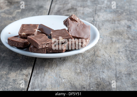 chocolate with hazelnut on wooden table, close up photo Stock Photo