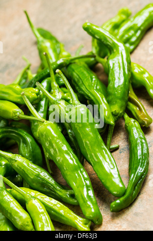 Closeup vertical photo of fresh, green sweet peppers on stone counter top Stock Photo