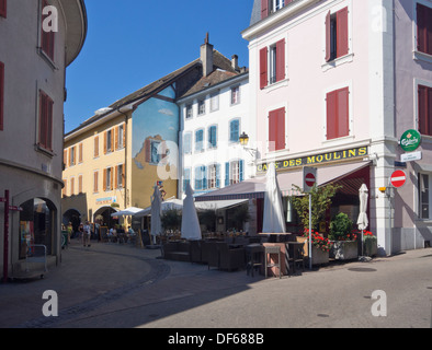 Nyon, a Swiss town on the shores of Lake Geneva in Switzerland, narrow pedestrian street with restaurants and mural Stock Photo