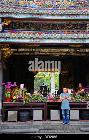 Buddhist worshipers taking prays and offerings at the Baoan temple in Taipei city, Taiwan. Stock Photo