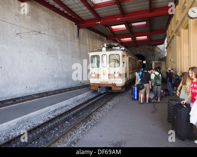 Aigle Leysin railway in the Vaud canton of Switzerland, passengers boarding the train in the Feydey station Stock Photo