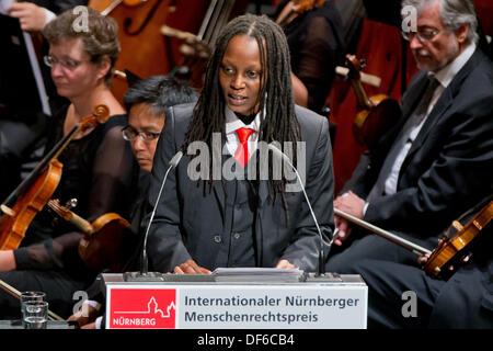 Nuremberg, Germany. 29th Sep, 2013. Ugandan human rights activist Kasha Jacqueline Nabagesera (C) gives a speech at the ceremony to receive the Nuremberg International Human Rights Award in Nuremberg, Germany, 29 September 2013. The city of Nuremberg is honoring the 33 year old for her work to ensure the rights of homosexual and bisexual people in her homeland. Photo: DANIEL KARMANN/dpa/Alamy Live News Stock Photo