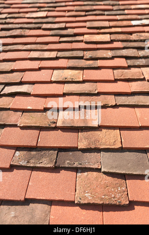 Handmade old Kent Peg and Clay Plain tiles mixed in with modern roofing tiles to give sympathetic restoration effect Stock Photo