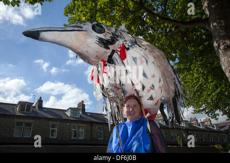 Giant animal puppet caricature masquerade celebration at Skipton UK. 29th September, 2013. International Puppet Festival.  Large Scale Puppetry  Giant Bird at Skipton's biennial international puppet festival featuring puppet theatre companies from all over Europe. The events offered 44 ticketed performances plus 32 free street performances.  From large giant puppets to puppets so small that they are invisible, the 5th Skipton International Puppet Festival was animated with hands, feet, toys, fruit, shadows and with puppets of a much more traditional character. Stock Photo