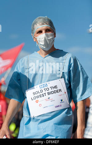 Manchester, UK. 29th Sept 2013. A male protester wearing a surgeon's uniform during a North West TUC organised march and rally intending to defend National Health Service (NHS) jobs and services from cuts and privatisation. The march coincides with the Conservative Party Conference 2013 being held in the city. Credit:  Russell Hart/Alamy Live News.