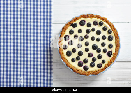 Blueberry tart on checkered background. Top view. Stock Photo