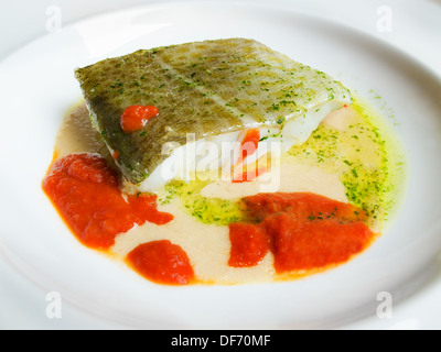 Cod in green sauce and tomato sauce, Basque cookery. Stock Photo