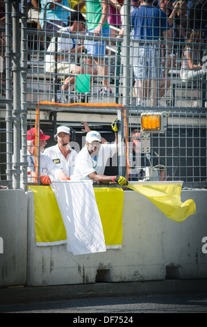 Yellow Flags being waved at the Baltimore Grand Prix Stock Photo