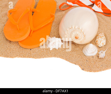 orange sandals and seashells on sand Stock Photo