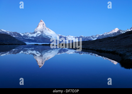 Mt Matterhorn reflected in Stellisee Lake at dusk, Zermatt, Canton of Valais, Switzerland Stock Photo