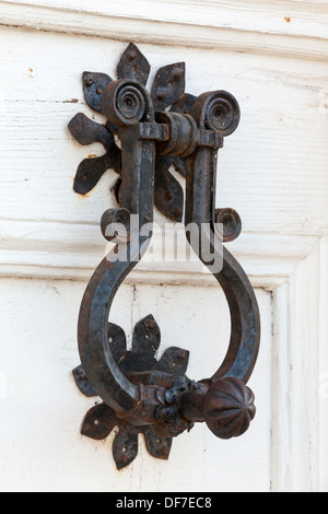 Vintage black metal knocker on white wooden door Stock Photo