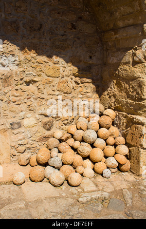Canon balls stored alongside a wall at the ancient city of Aptera in western Crete. Stock Photo