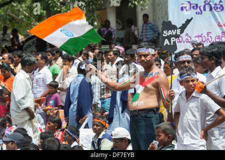 Indian man waving a flag at a protest rally against the creation of Telangana.  Puttaparthi, Andhra Pradesh, India Stock Photo