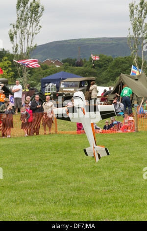 Radio controlled model airplane doing aerobatic tailslide during a flying display given by by members of Bury Model Flying Club. Stock Photo