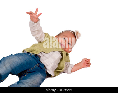 Baby falling down isolated on white background. Blurred motion of baby body and selective focus on the head Stock Photo