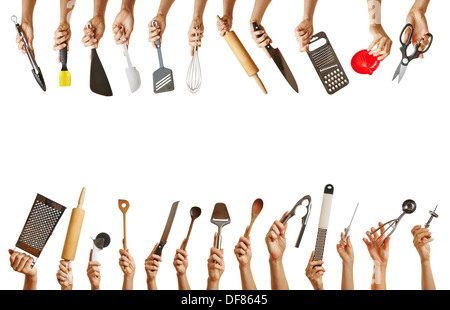Frame with many hands holding different kitchen tools like knife, scissors and spoon Stock Photo