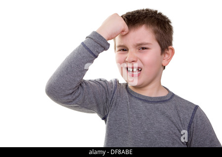 Kid knocking his head looks very regretful about what he did Stock Photo