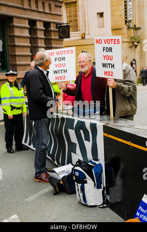 Manchester, UK. 30th Sep, 2013. Two protestors campaign against the introduction of the High Speed 2 rail line outside of Conservative Party Conference Credit:  Paul Swinney/Alamy Live News Stock Photo