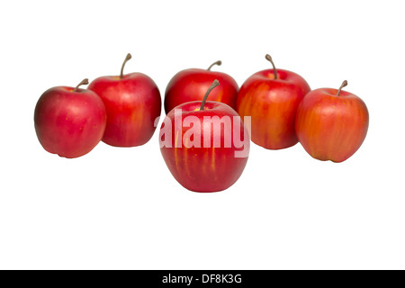 Five red apples are arranged in a semi-circle around the isolated apple. Stock Photo