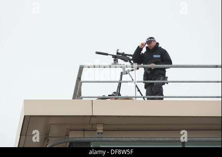 Manchester, UK. 30th Sept, 2013. A police 'sniper' positioned on the roof of the Premier Inn hotel on Lower Mosley Street opposite the Manchester Central exhibition centre observes the streets below. The exhibition centre was hosting the Conservative Party Conference in September 2013. Credit:  Russell Hart/Alamy Live News. Stock Photo