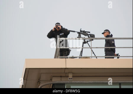 Manchester, UK. 30th Sept, 2013. Two police 'snipers' positioned on the roof of the Premier Inn hotel on Lower Mosley Street opposite the Manchester Central exhibition centre observes the streets below. The exhibition centre was hosting the Conservative Party Conference in September 2013. Credit:  Russell Hart/Alamy Live News. Stock Photo