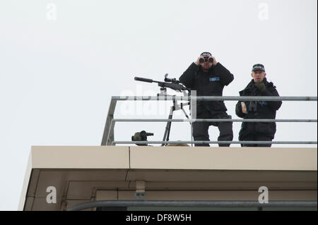 Manchester, UK. 30th Sept, 2013. Two police 'snipers' positioned on the roof of the Premier Inn hotel on Lower Mosley Street opposite the Manchester Central exhibition centre observes the streets below. The exhibition centre was hosting the Conservative Party Conference in September 2013. Credit:  Russell Hart/Alamy Live News. Stock Photo